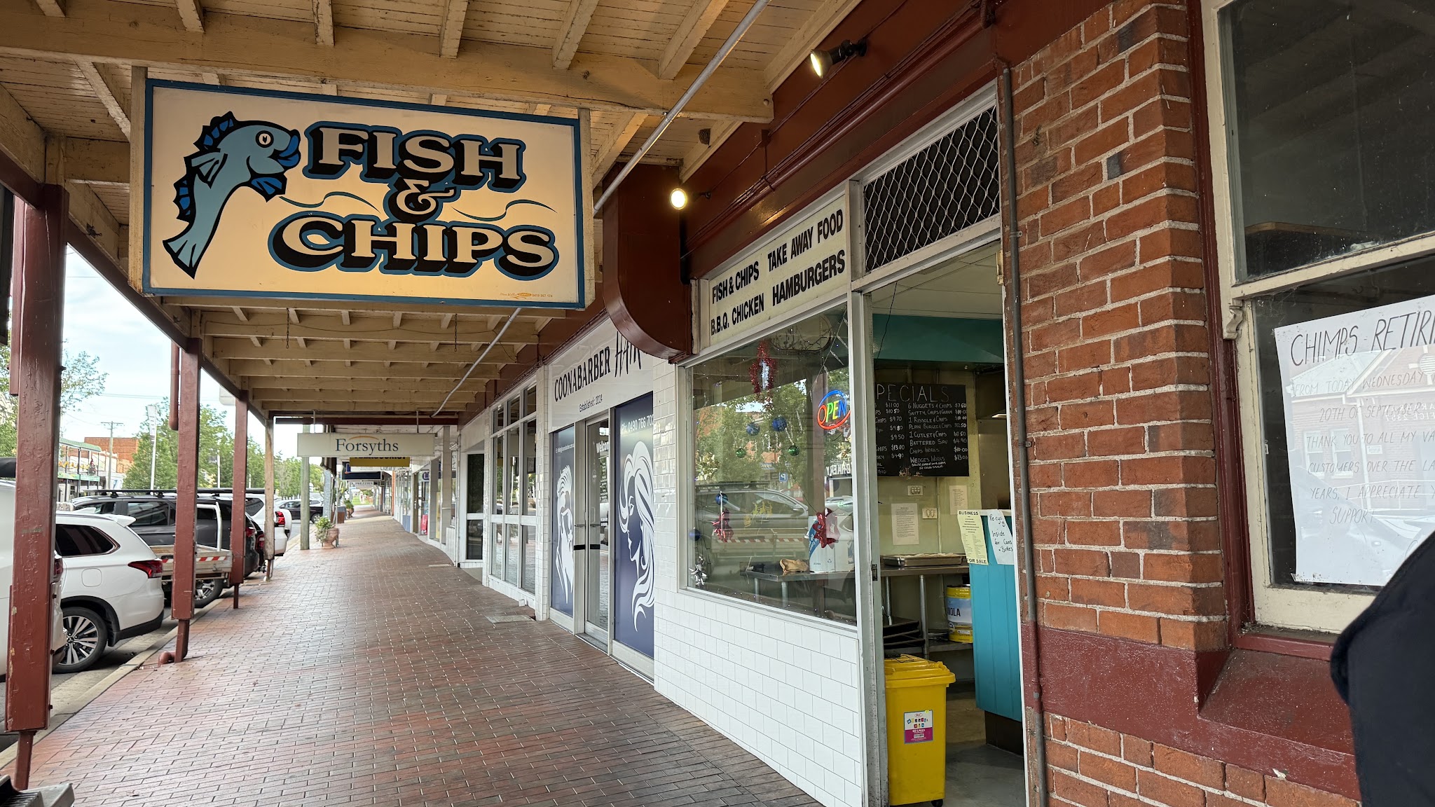 Coona Fish Shop's hanging Fish & Chips sign under the verandah on John Street