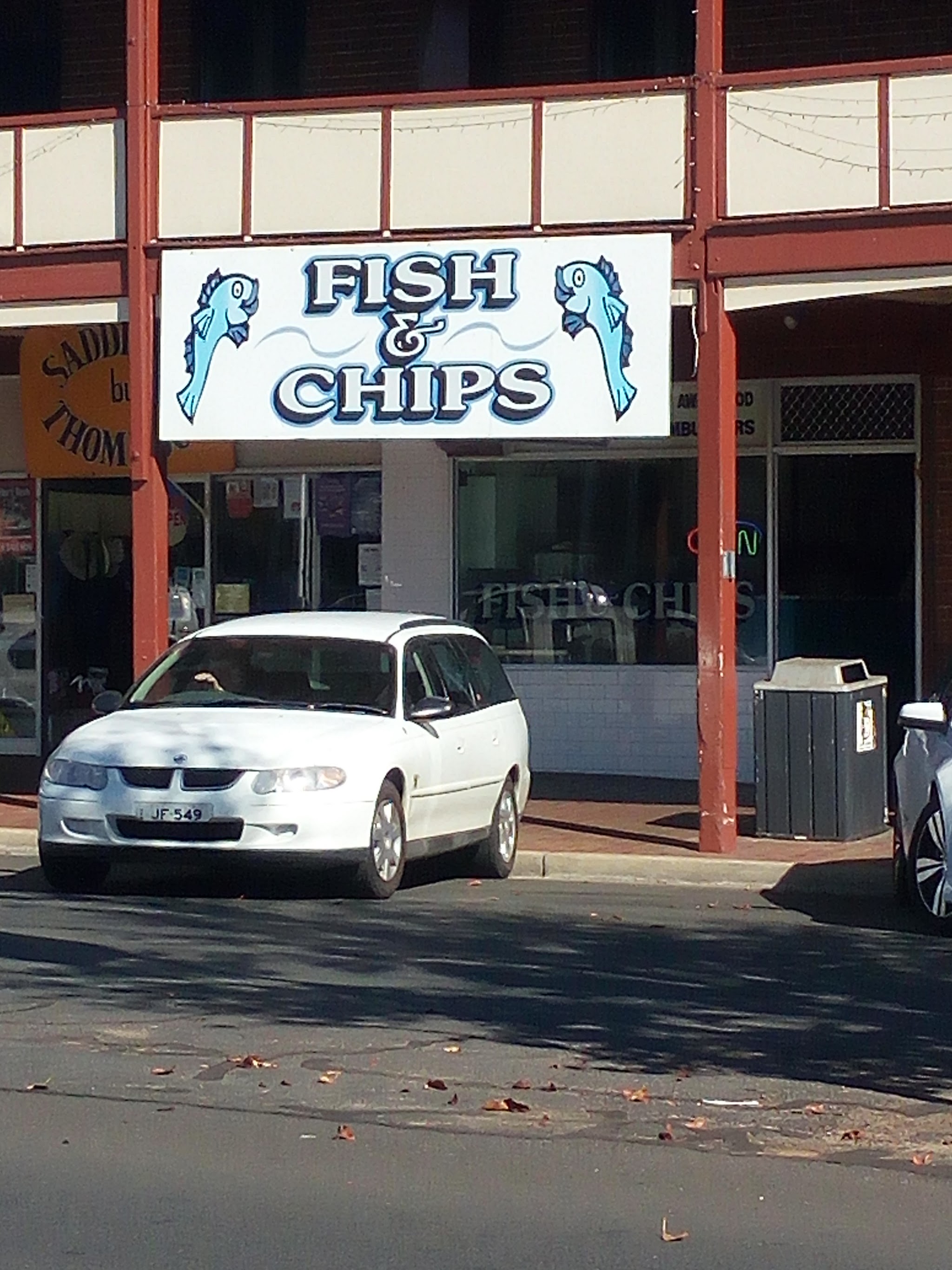 The Fish & Chips sign with two cartoon fish above the shopfront
